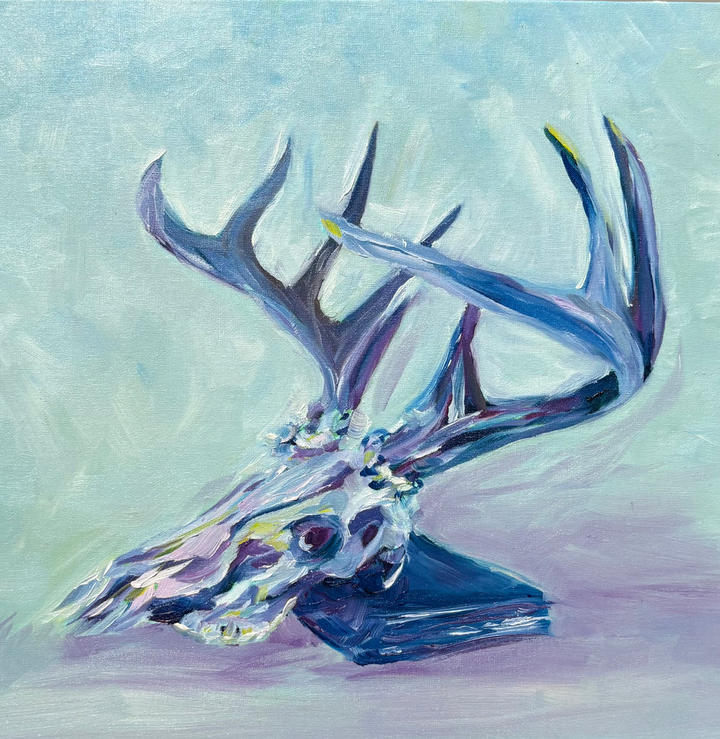 colorful oil painting of a deer skull with a large rack of antlers, leaning on a book - colors are jewel-toned pinks, purples, yellows and blues