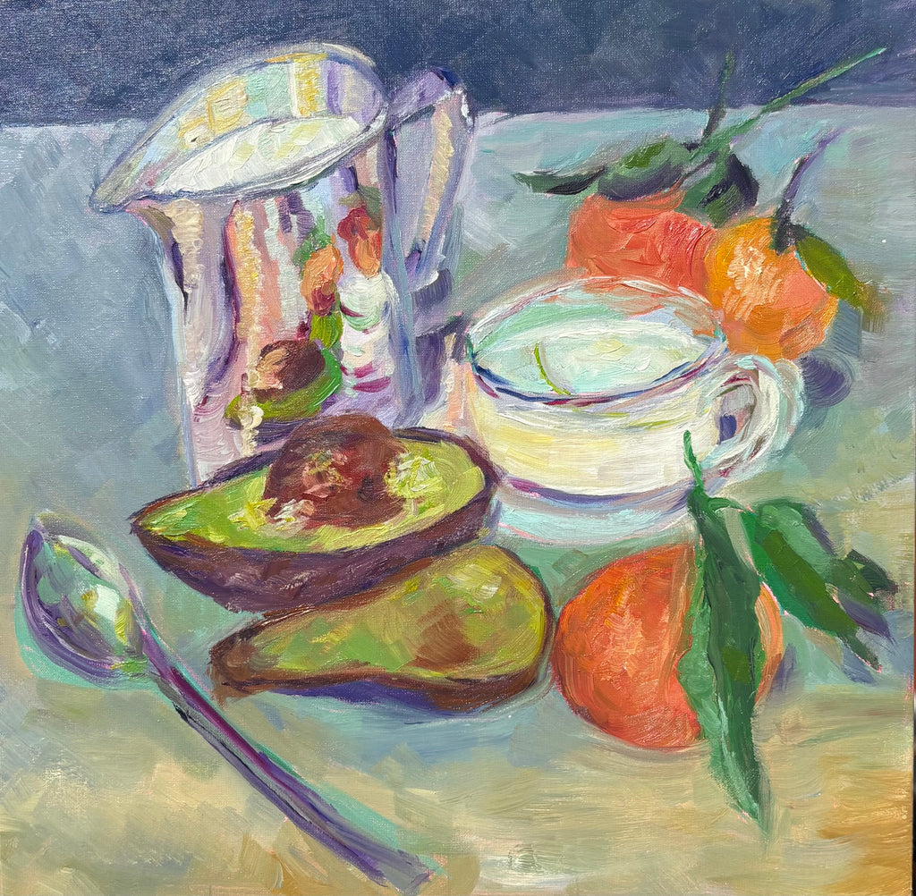 Oil painting of an impressionist style still life with a shiny pitcher, halved avocado, cup of milk, and oranges.