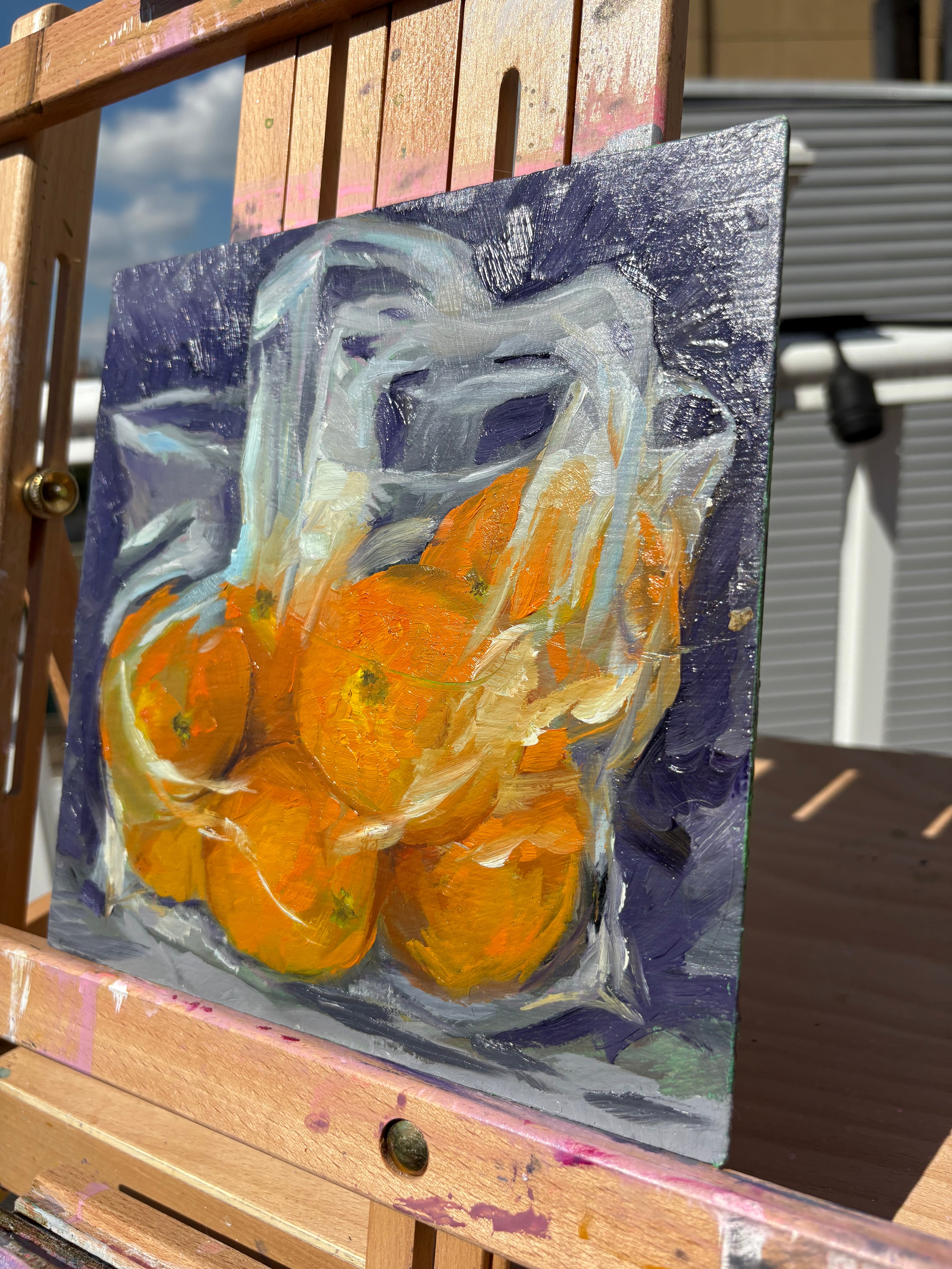 A small, bright painting of a clear plastic bag full of oranges on a purple background
