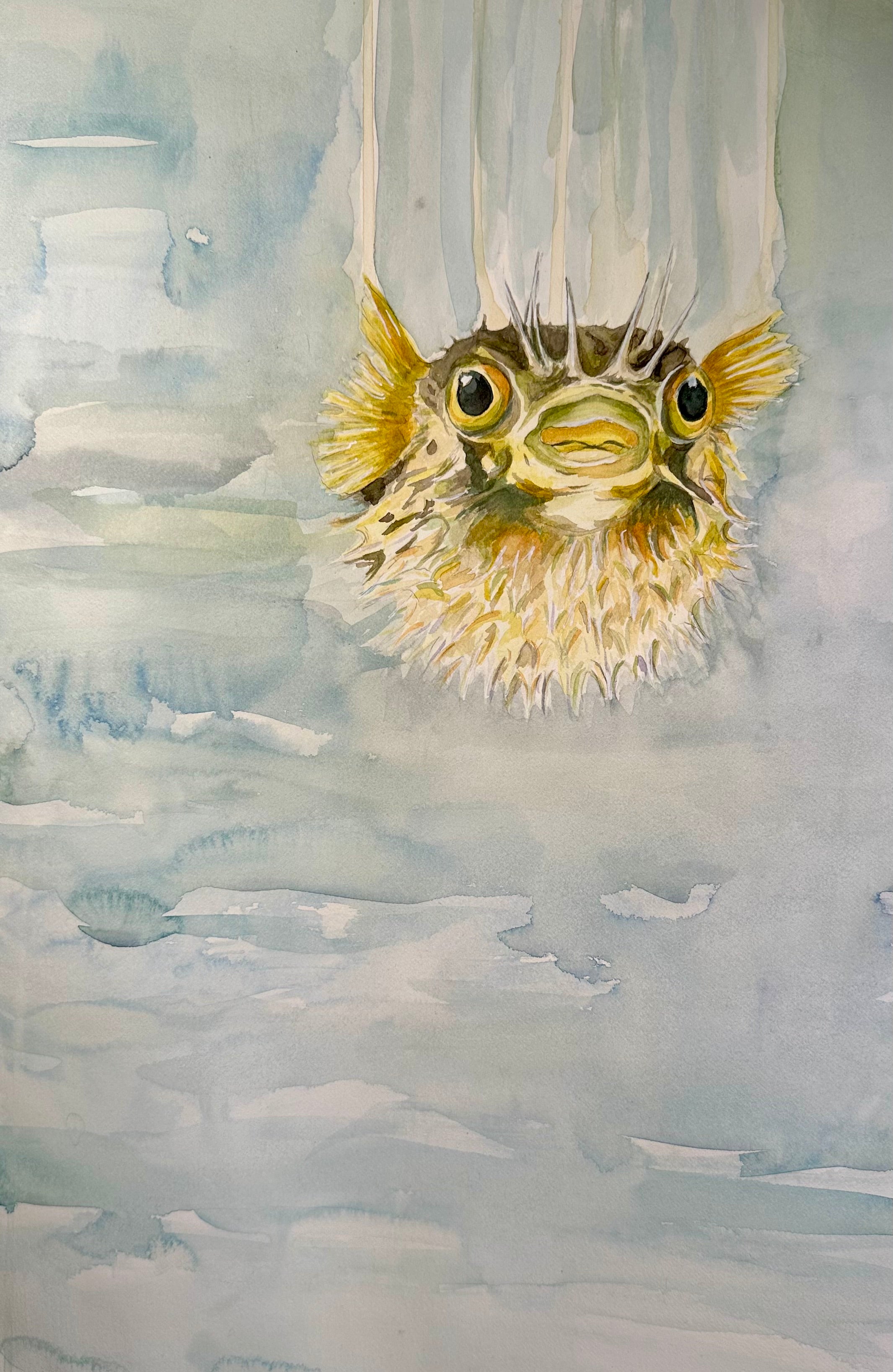 Original Hand-painted puffer fish hovering on a large bluish green watery background; painted on Fabriano hot pressed 300gsm/140lb, 12x18in paper with watercolor, gouache, and ink; Unframed