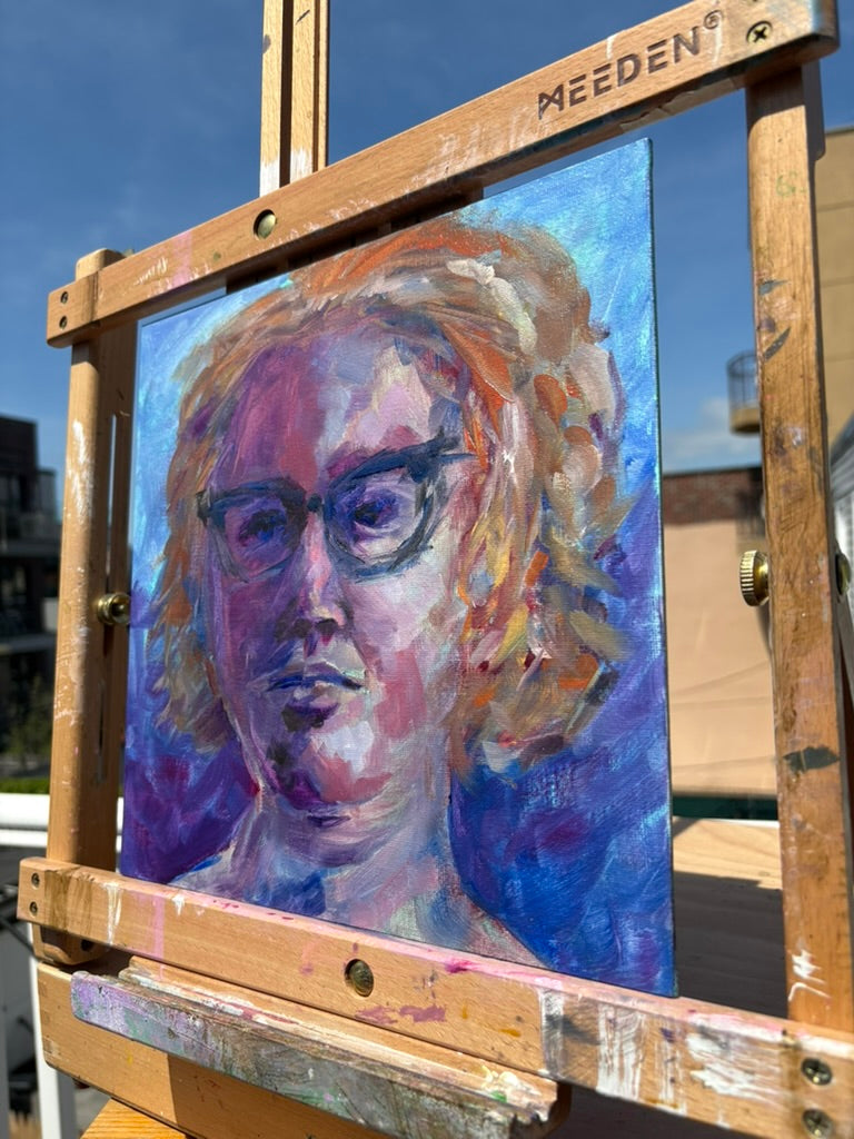 Impressionist self-portrait oil painting of a woman with curly amber hair and dark cat-eye glasses, painted in cool purples, blues, and warm golds against a violet background with expressive loose brushwork.