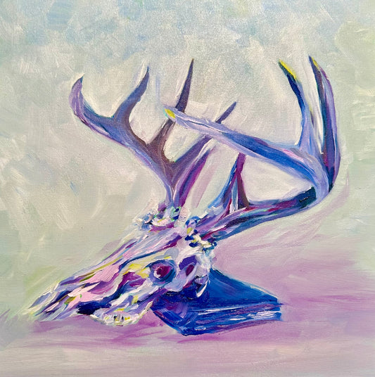 colorful oil painting of a deer skull with a large rack of antlers, leaning on a book - colors are jewel-toned pinks, purples, yellows and blues